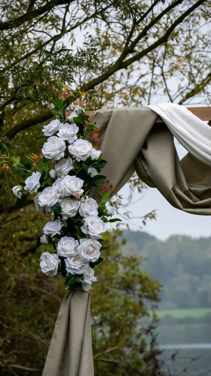 White floral arch by the water